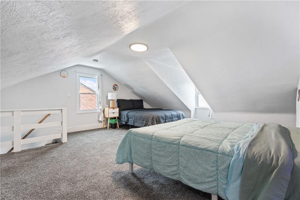 1015 Constance Street Pittsburgh, PA 15212 - Photo 20 of 25 a bed room with a bed and a couch