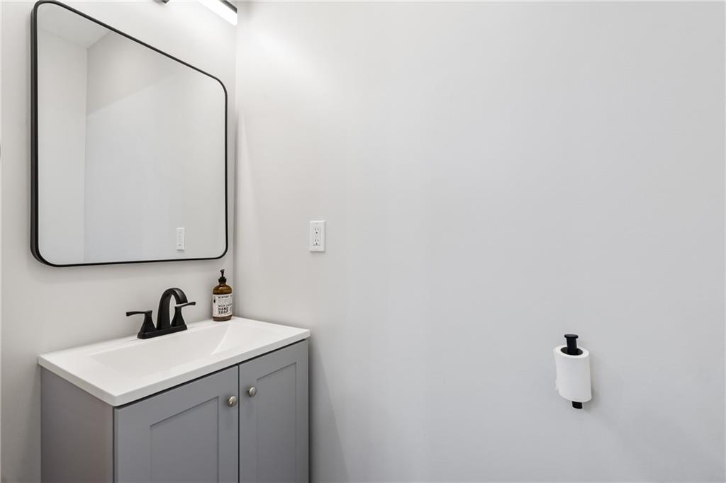 1015 Constance Street Pittsburgh, PA 15212 - Photo 8 of 25 a bathroom with a sink and a mirror