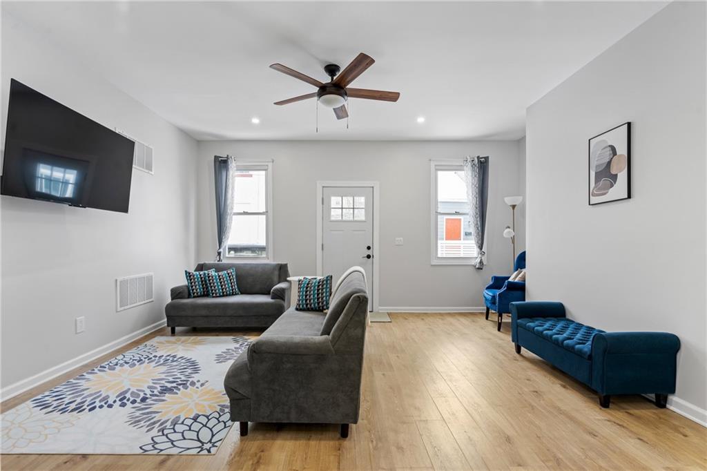 1015 Constance Street Pittsburgh, PA 15212 - Photo 10 of 25 a living room with furniture and a flat screen tv