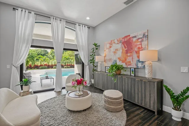 a living room with furniture and a potted plant