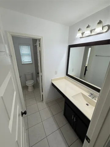 a view of bathroom with a sink and a mirror