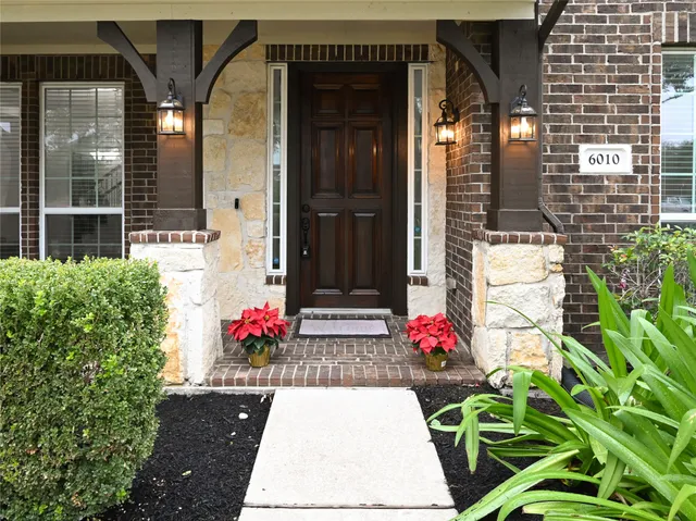 a bunch of flowers in front of house
