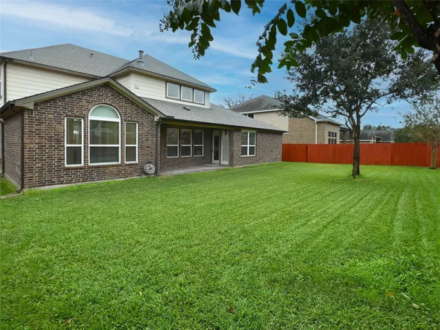 a view of a house with a yard and sitting area