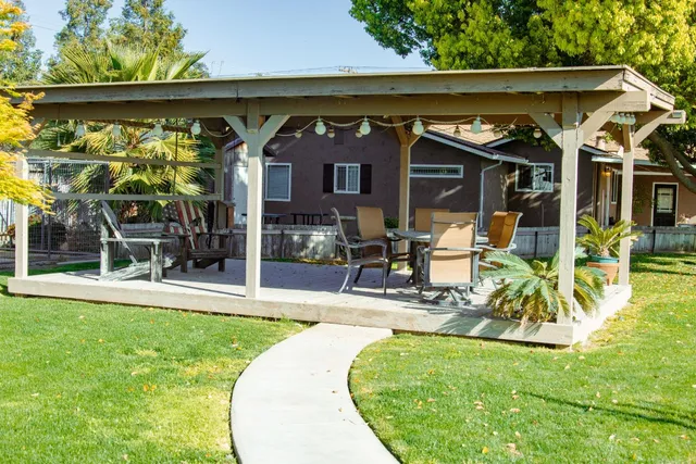 a view of yard with swimming pool and green space