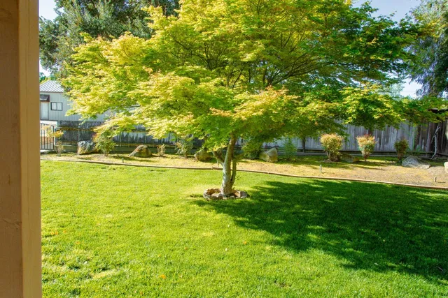 a swimming pool with outdoor seating and yard
