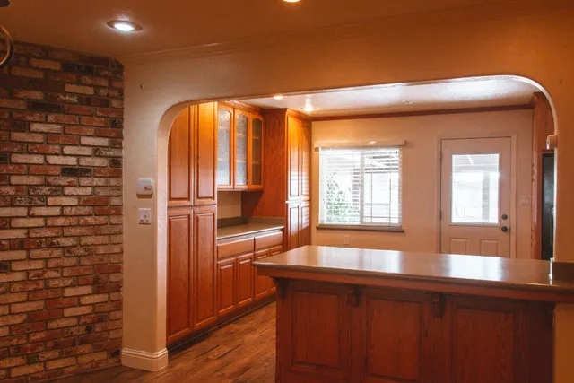 a kitchen with stainless steel appliances granite countertop a coffee maker a sink and a refrigerator