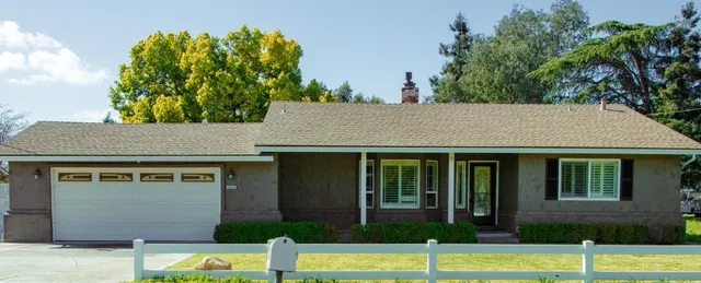 a view of backyard with outdoor seating and plants