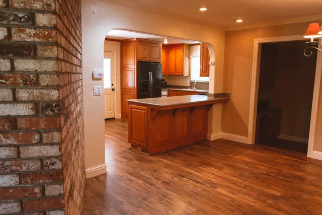 a kitchen with stainless steel appliances granite countertop a refrigerator and a stove
