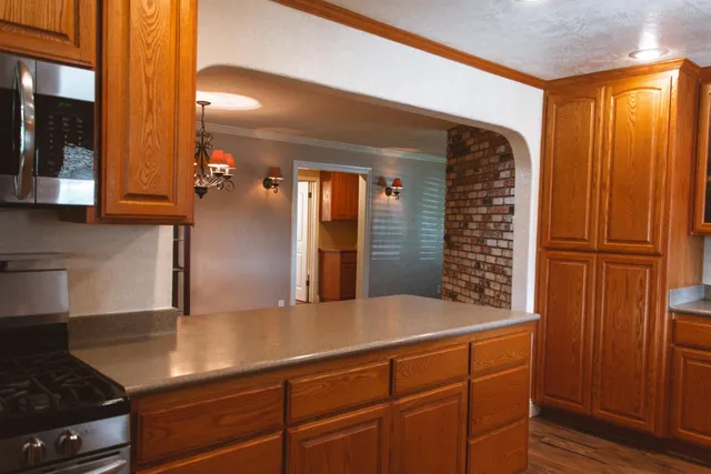 a view of a kitchen cabinets and a refrigerator