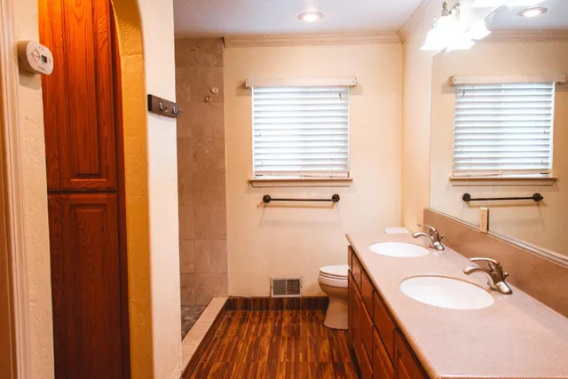 a view of a room with wooden floor