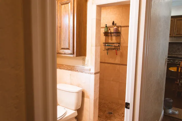 a kitchen with a refrigerator a stove a sink dishwasher with a dining table and chairs with wooden floor