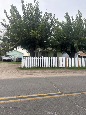 a white house that has a tree in front of it