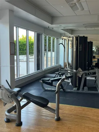 a room with gym equipment and a large window
