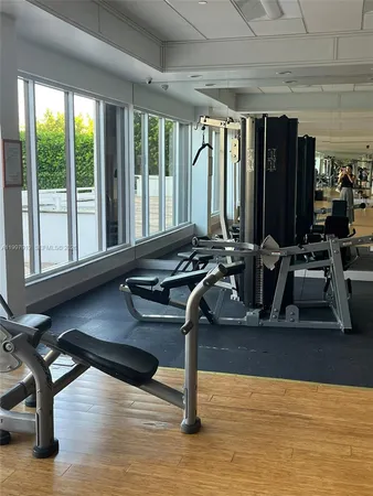 a room with gym equipment and a large window