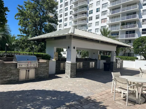 a view of a patio with dining table and chairs