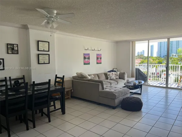 a living room with furniture and large windows