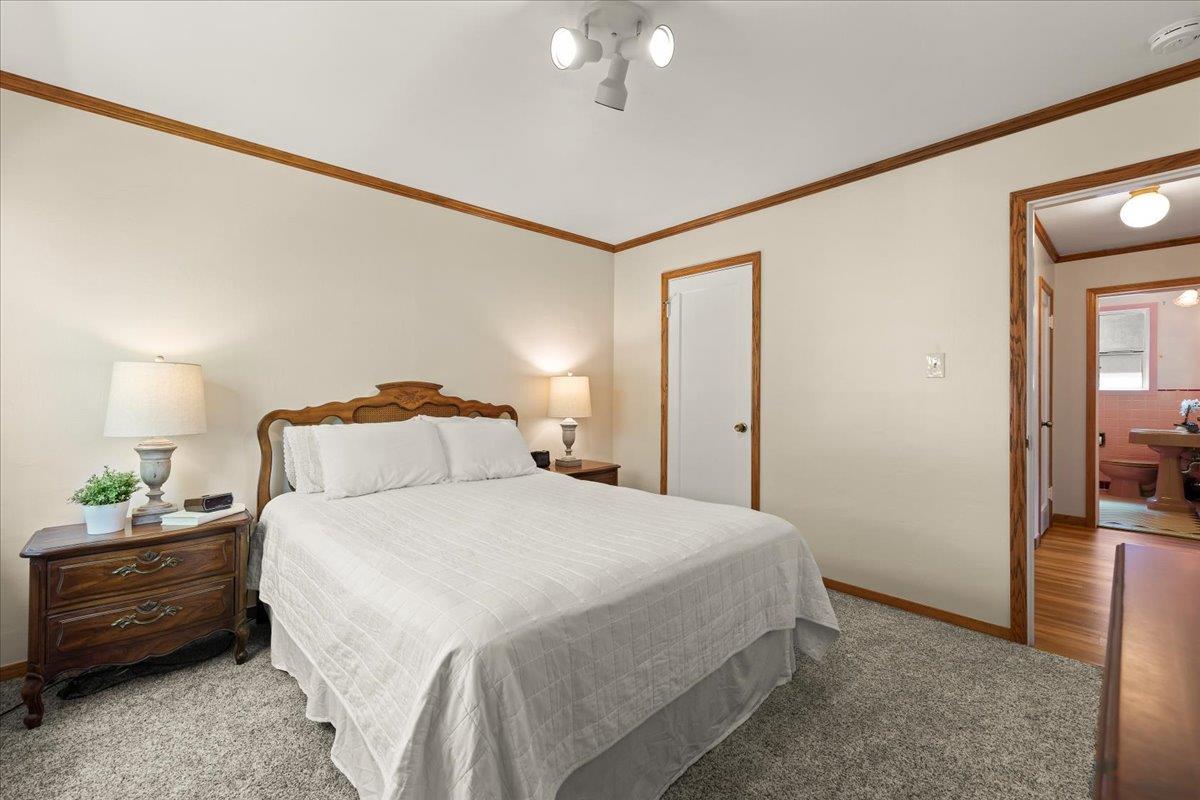 472 Helen Drive Millbrae, CA 94030 - Photo 16 of 35 a bedroom with a bed and a chandelier