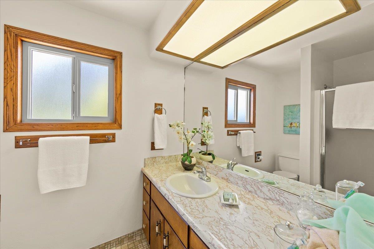 472 Helen Drive Millbrae, CA 94030 - Photo 24 of 35 a bathroom with a granite countertop sink and a mirror