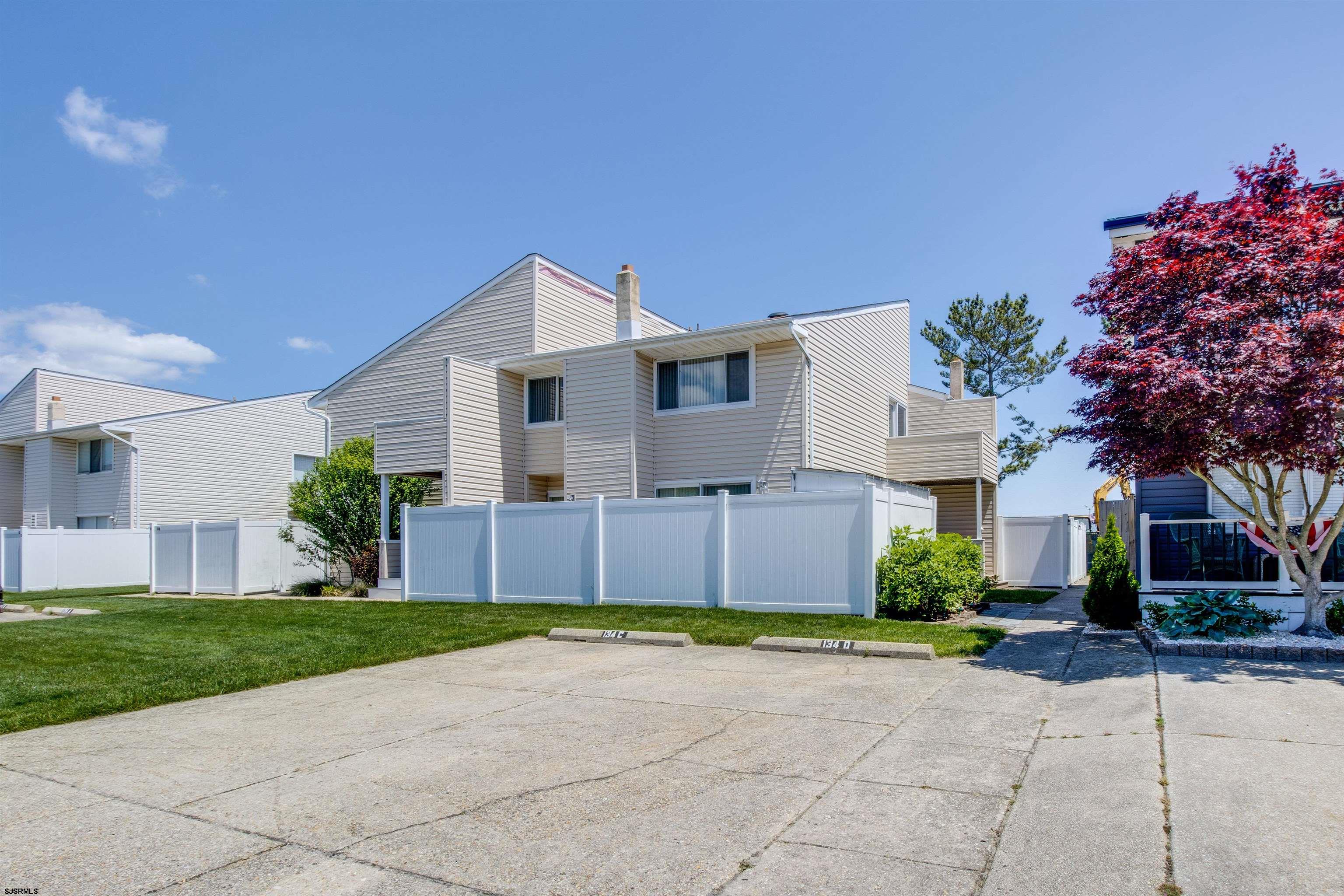 a front view of a house with a garden and plants