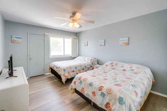 a bedroom with two beds and a chandelier