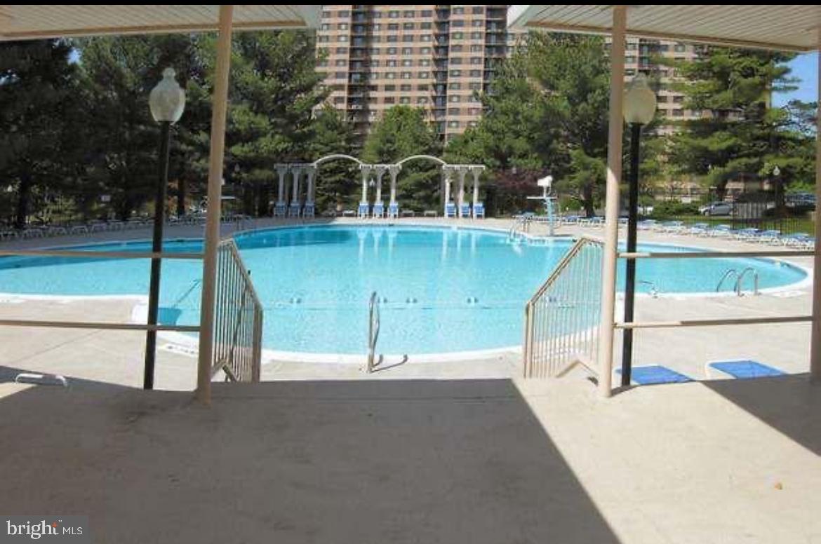 1111 University Boulevard West, Unit 501A Silver Spring, MD 20902 - Photo 12 of 13 a view of a swimming pool with a patio