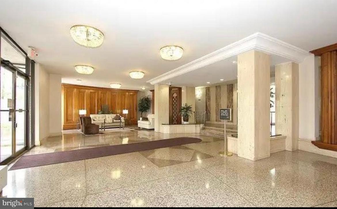 1111 University Boulevard West, Unit 501A Silver Spring, MD 20902 - Photo 13 of 13 a view of a lobby with a rug and a large window