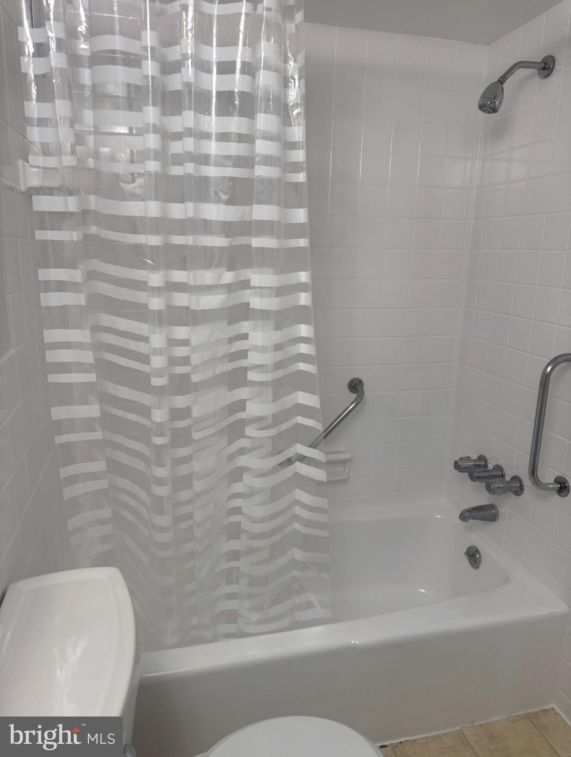 1111 University Boulevard West, Unit 501A Silver Spring, MD 20902 - Photo 9 of 13 a bathroom with a bathtub and a toilet