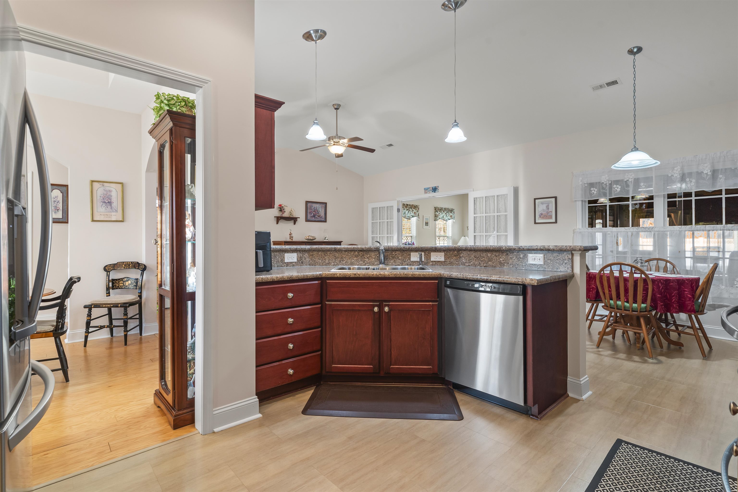 830 Payne Court Conway, SC 29526 - Photo 14 of 38 Kitchen featuring decorative light fixtures, appliances with stainless steel finishes, light wood-type flooring, lofted ceiling, and dark stone countertops
