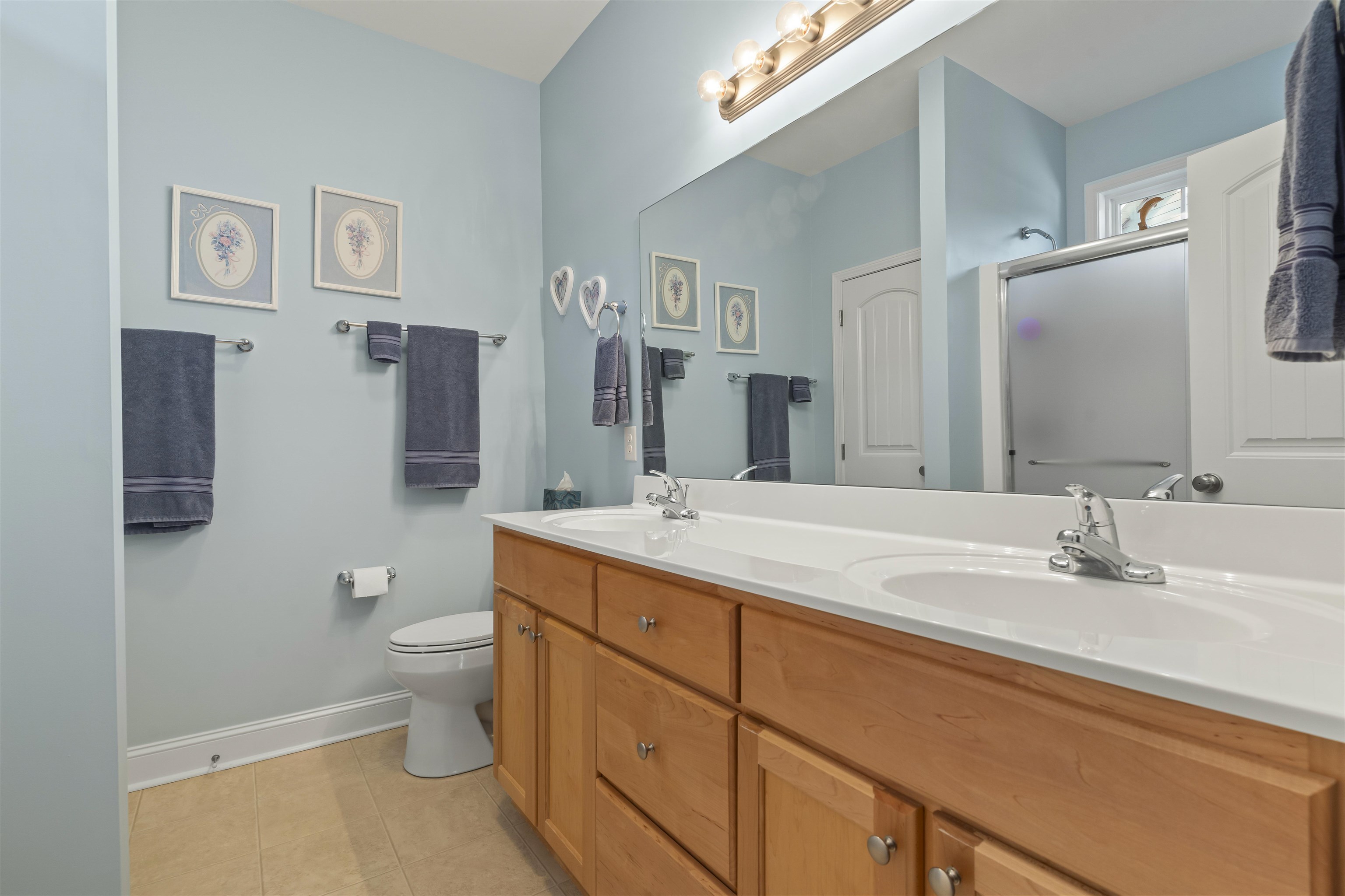 830 Payne Court Conway, SC 29526 - Photo 21 of 38 Bathroom featuring double vanity, a shower stall, and light tile patterned floors
