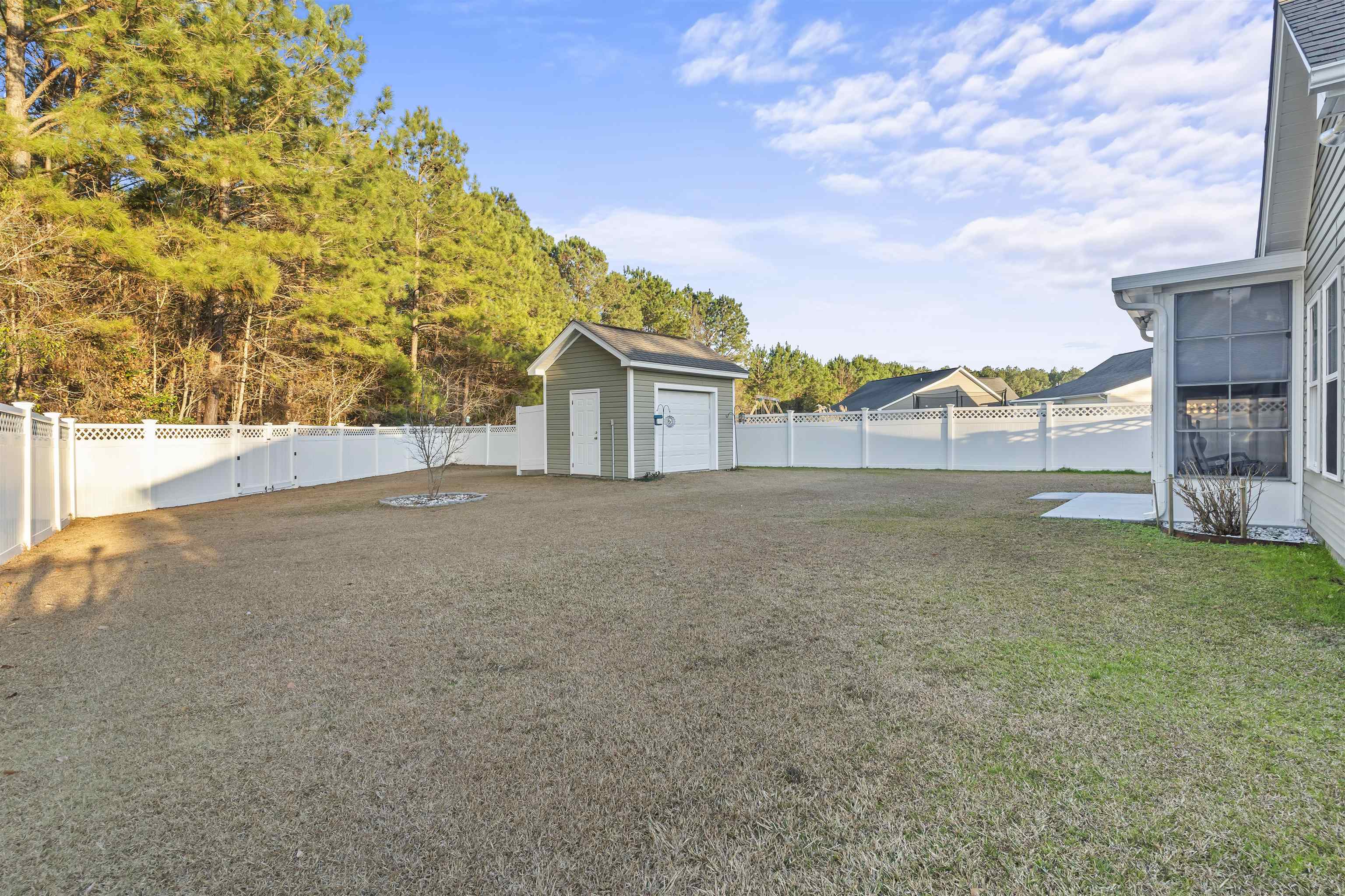 830 Payne Court Conway, SC 29526 - Photo 30 of 38 Fenced backyard featuring a sunroom and a storage shed