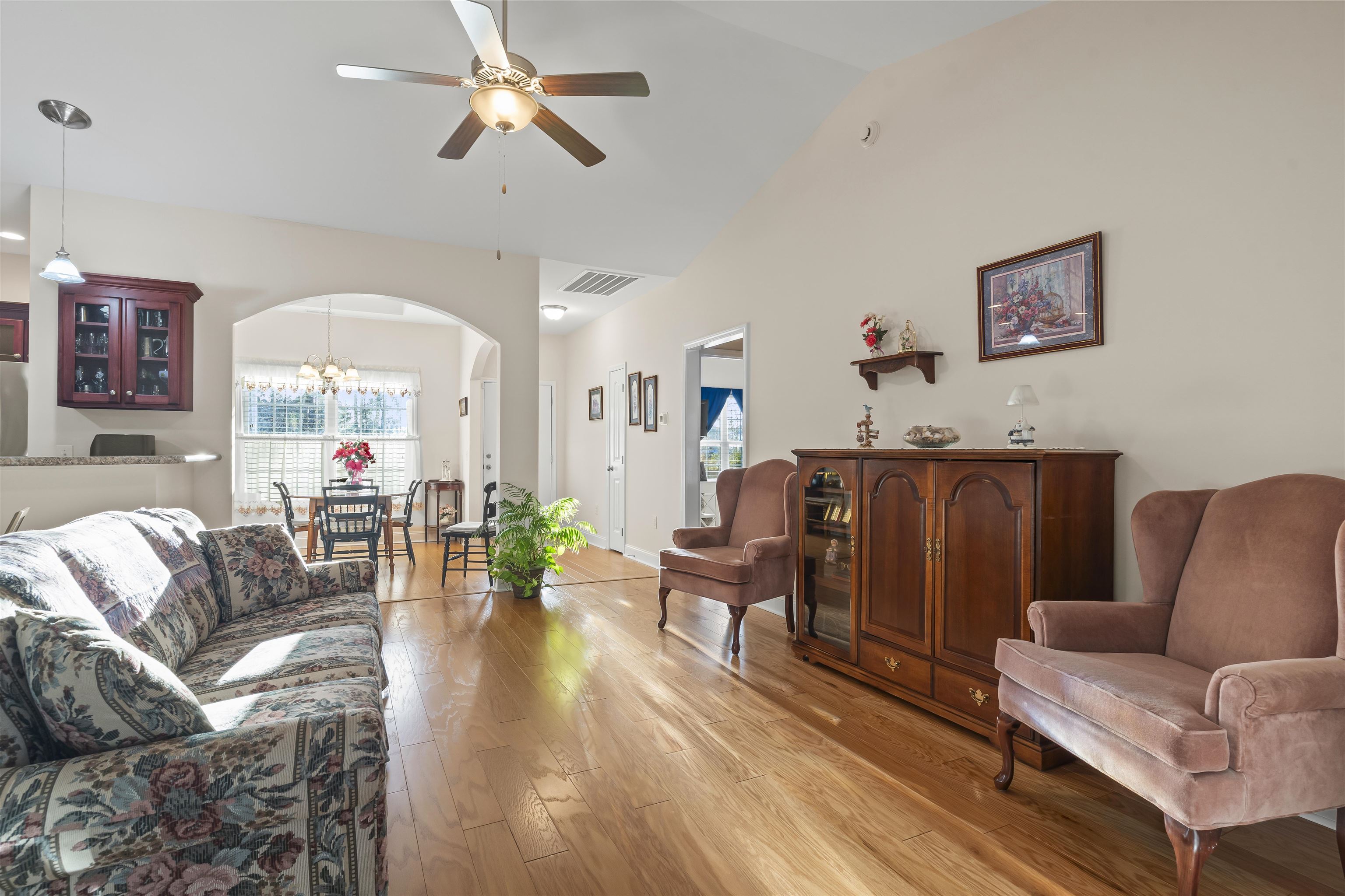 830 Payne Court Conway, SC 29526 - Photo 6 of 38 Living area with a chandelier, light wood-type flooring, arched walkways, lofted ceiling, and a ceiling fan