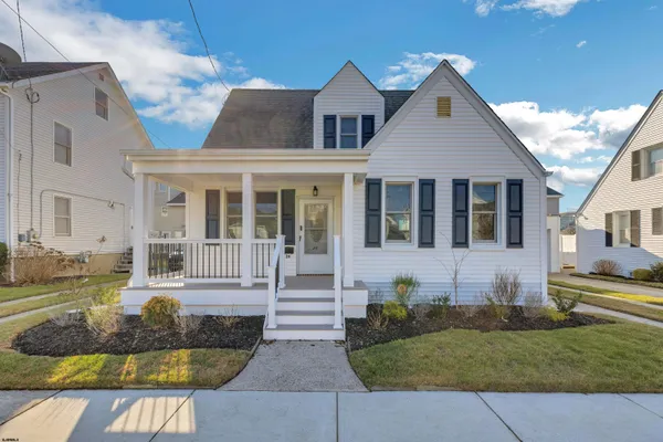 a living room with furniture a window and a chandelier