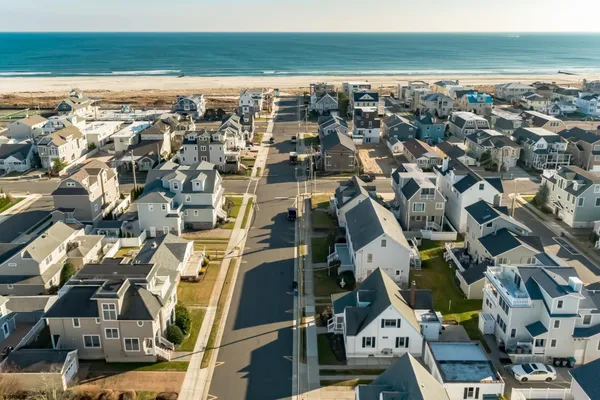 a dining room with furniture a chandelier and wooden floor