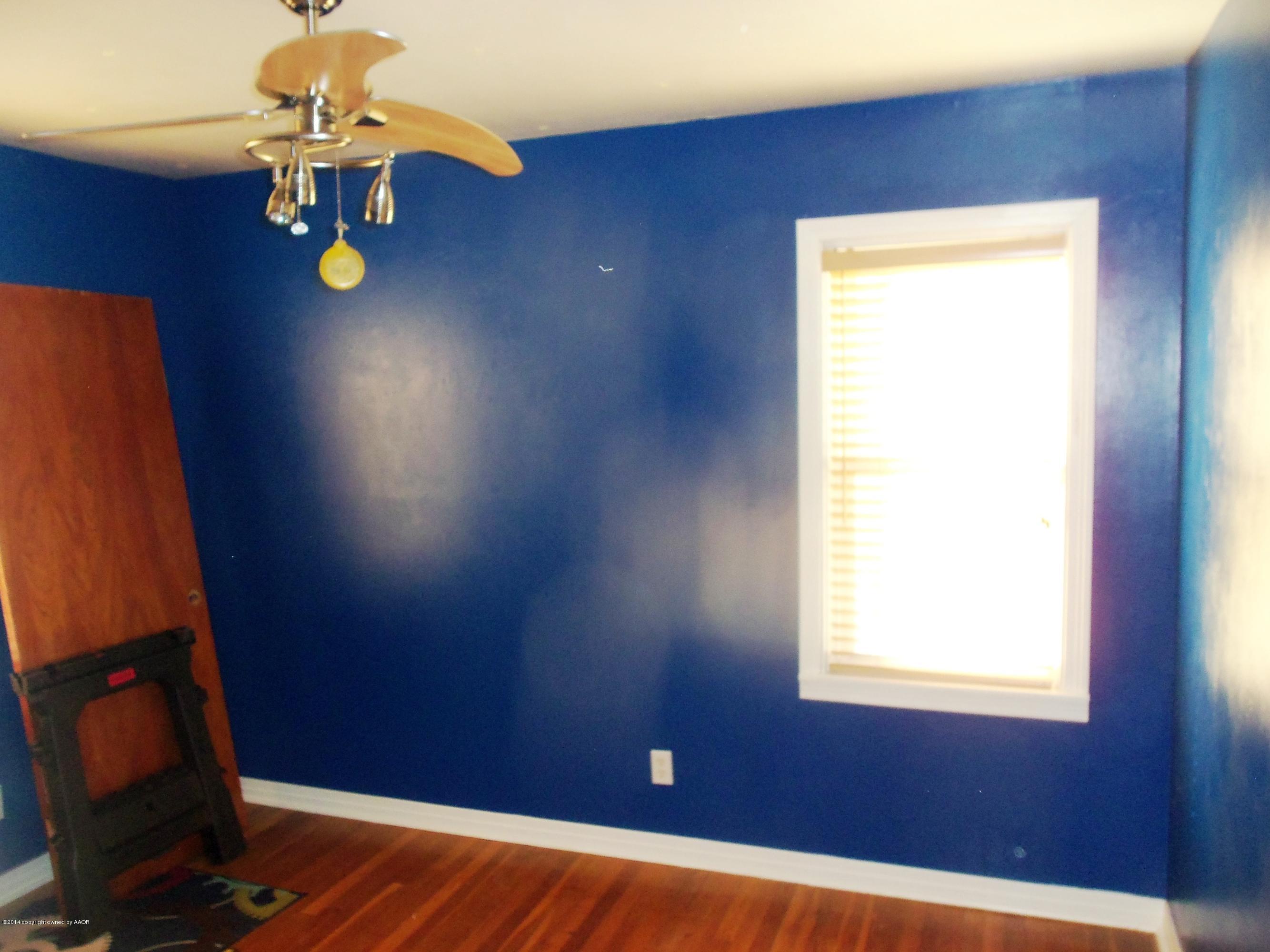 4307 Parker Street Amarillo, TX 79110 - Photo 14 of 16 a view of an empty room with window and wooden floor