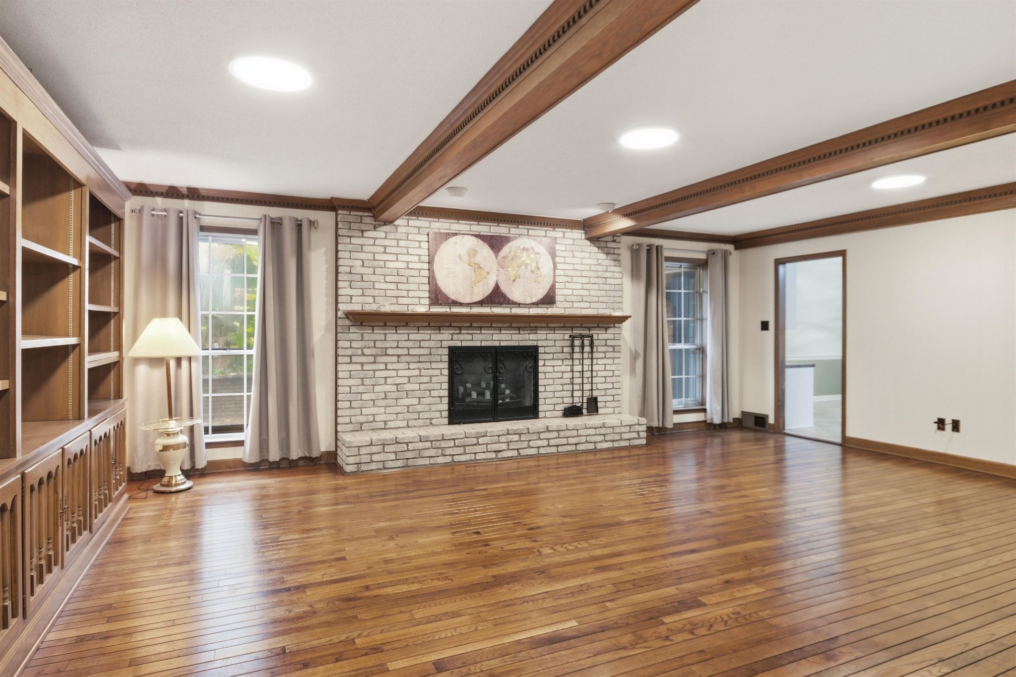 1015 Palmer Road Memphis, TN 38116 - Photo 7 of 26 a view of an empty room with wooden floor fireplace and a window
