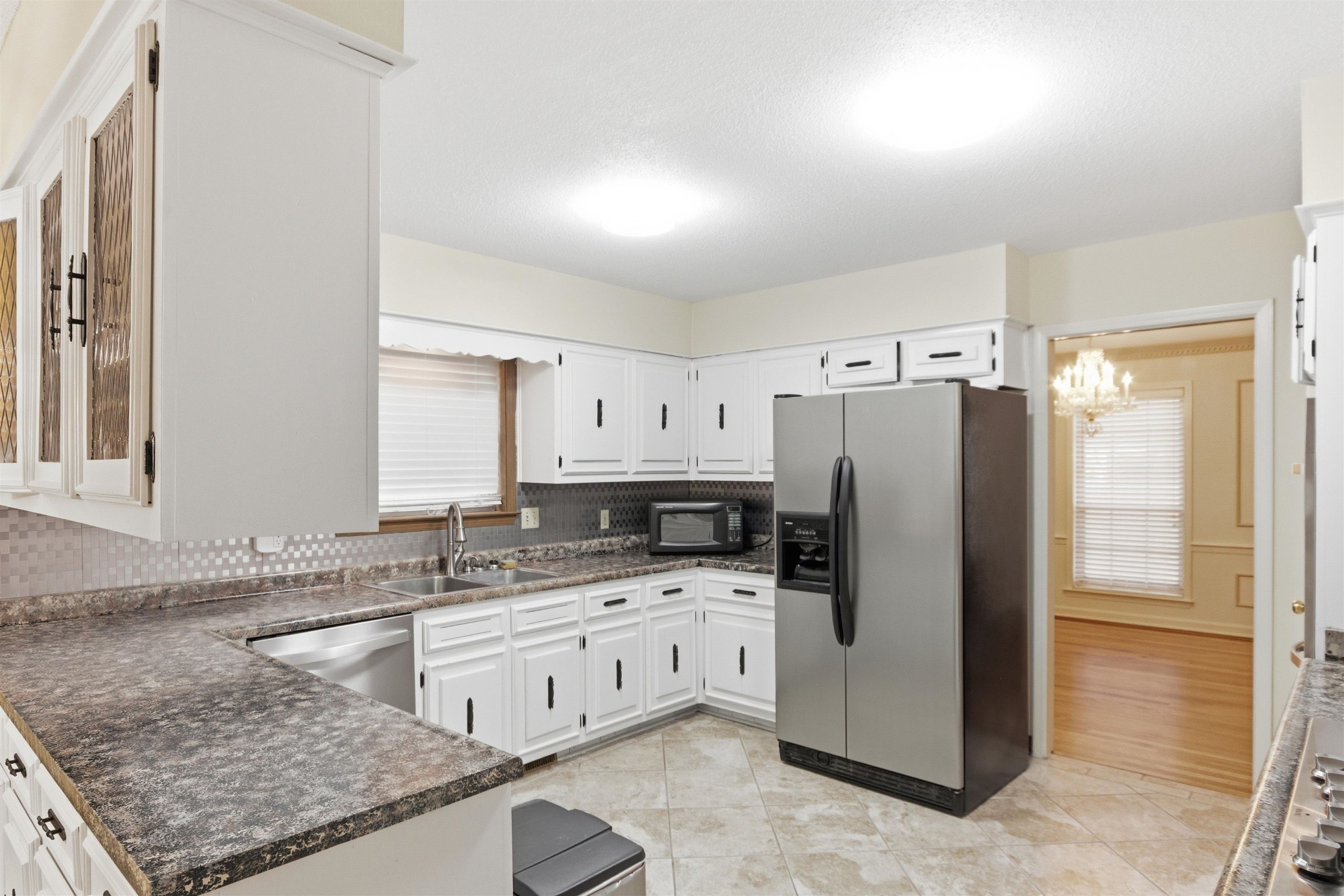 1015 Palmer Road Memphis, TN 38116 - Photo 8 of 26 a kitchen with granite countertop a refrigerator sink stove and white cabinets