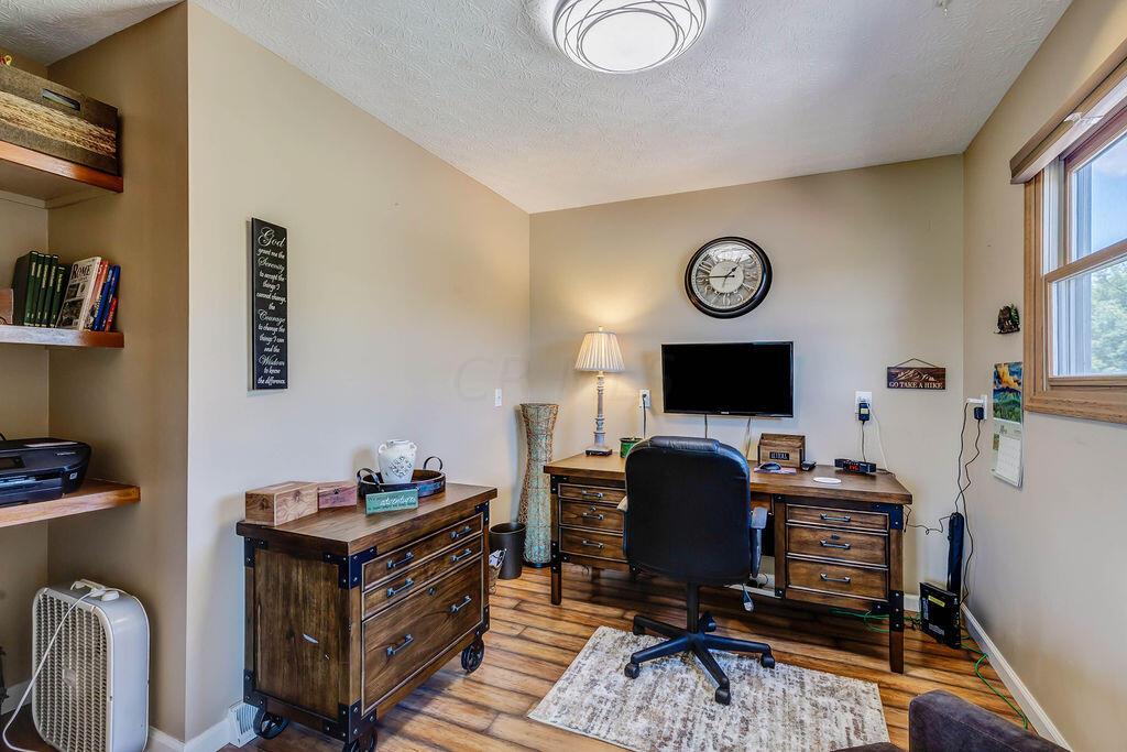 1300 Hubbard Road Galloway, OH 43119 - Photo 13 of 89 • Laminate flooring • Tan painted walls • Shelves remain • Ceiling light • Shades remain • Pocket door