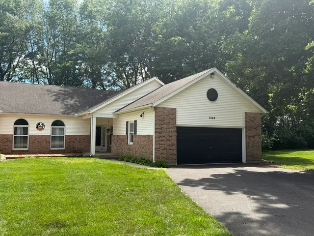 a front view of house with yard and green space