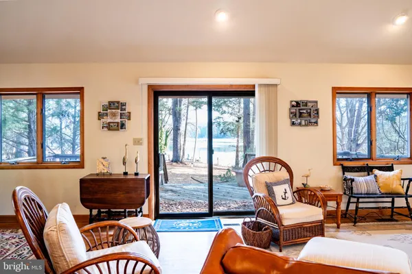 a living room with furniture a window and a chandelier