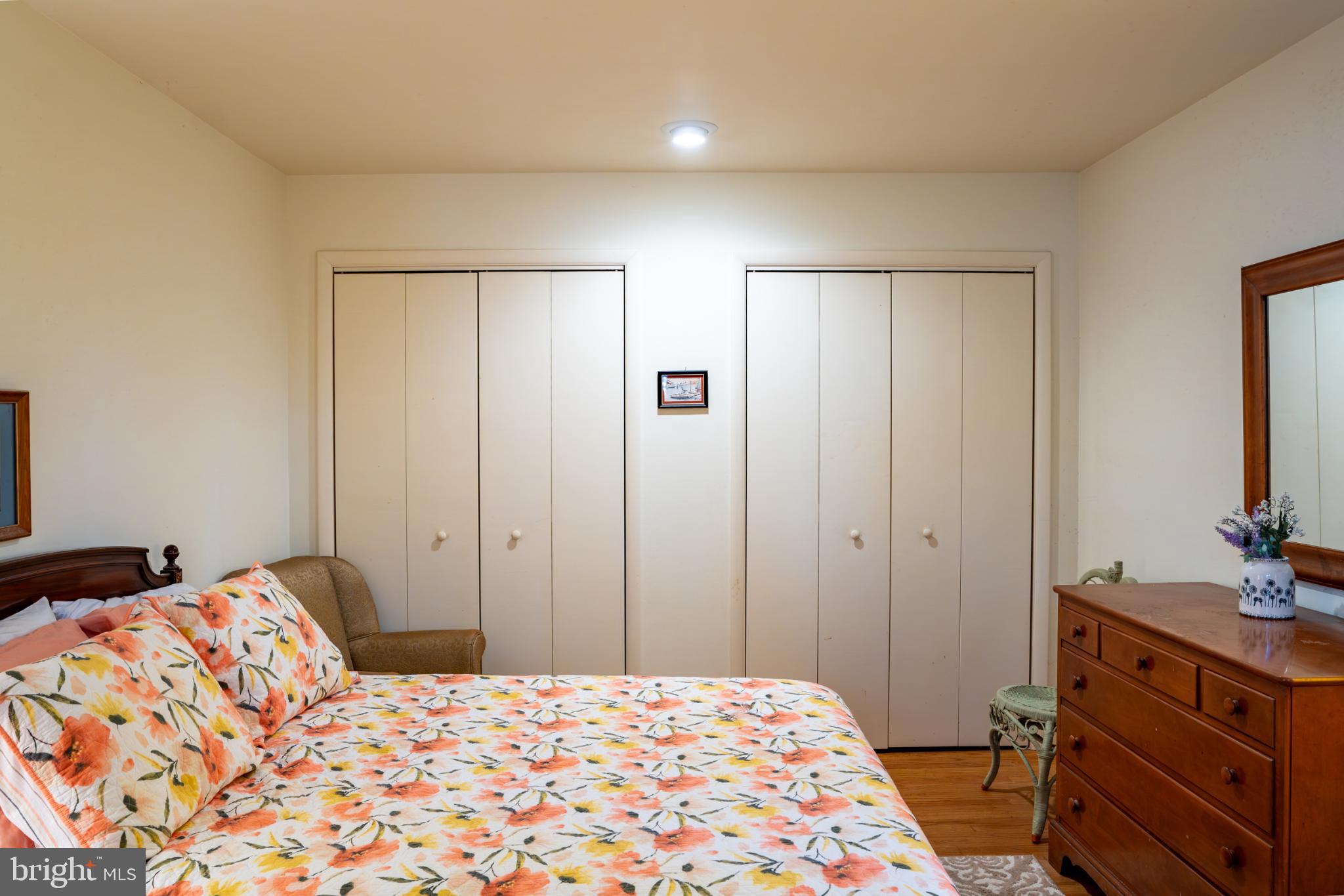 162 Youcomico Drive Lancaster, VA 22503 - Photo 17 of 31 a bedroom with a bed and a dresser