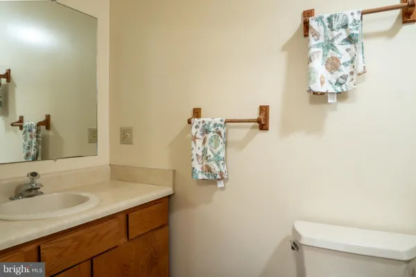a bathroom with a sink vanity mirror and toilet