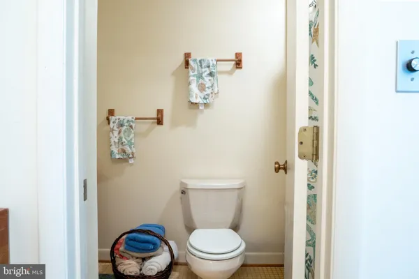 a white toilet sitting next to a bathroom sink