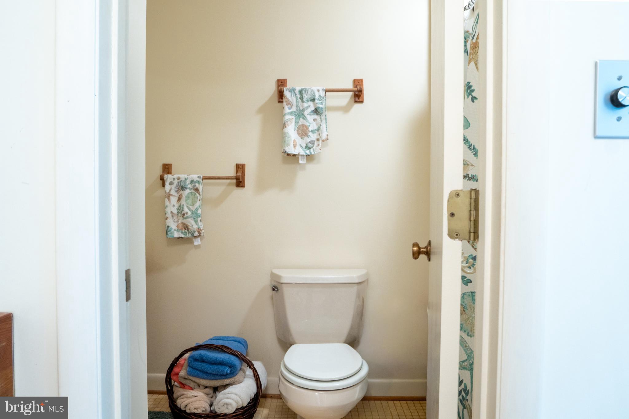 162 Youcomico Drive Lancaster, VA 22503 - Photo 22 of 31 a white toilet sitting next to a bathroom sink