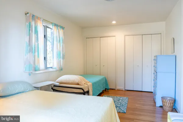 a bedroom with two beds and a window