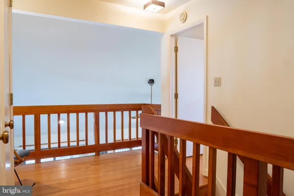 a view of staircase with railing and white walls