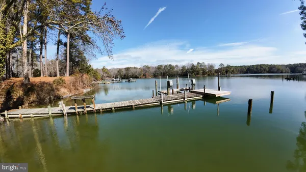 a view of a lake with a table and chairs