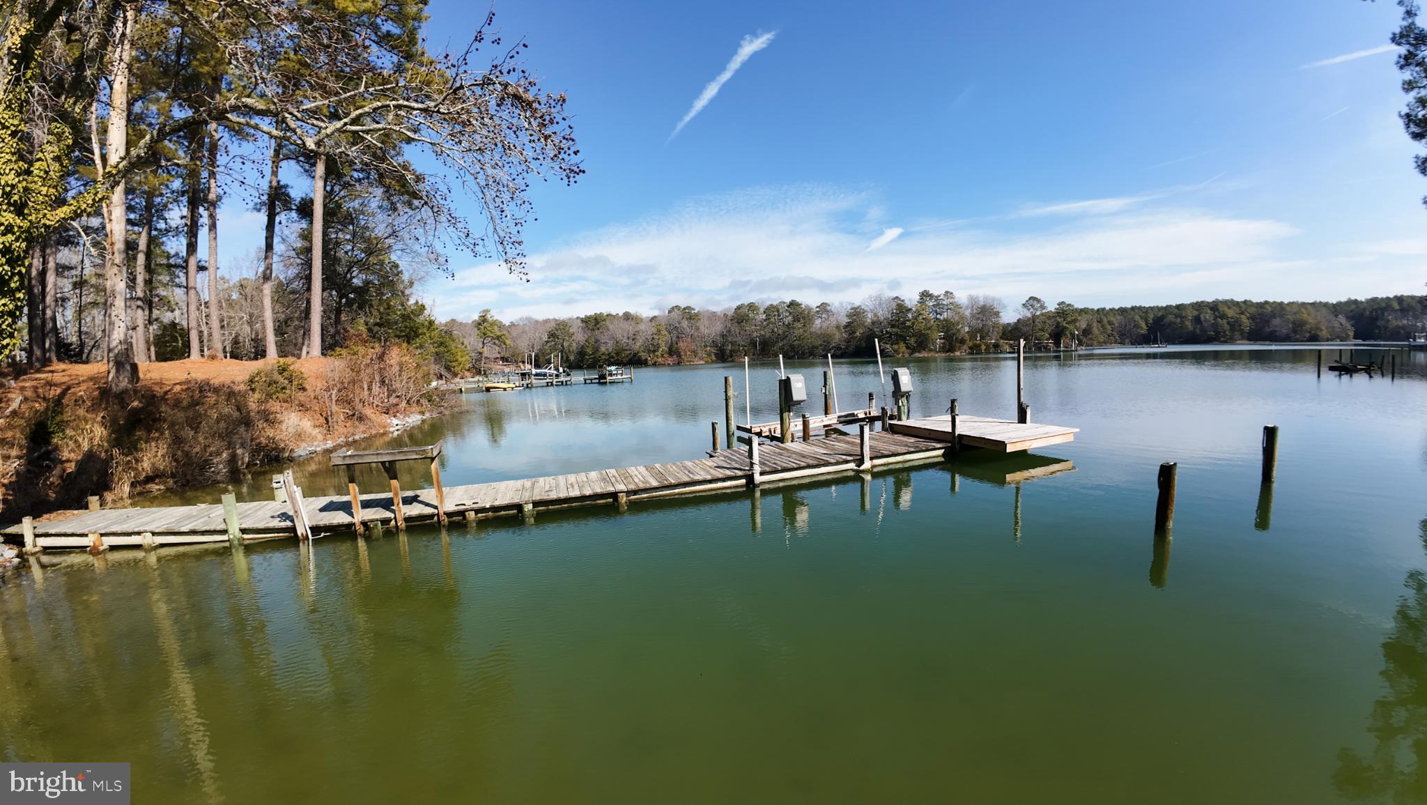 162 Youcomico Drive Lancaster, VA 22503 - Photo 30 of 31 a view of a lake with a table and chairs