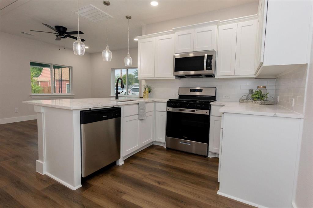 a kitchen with a sink cabinets and stainless steel appliances