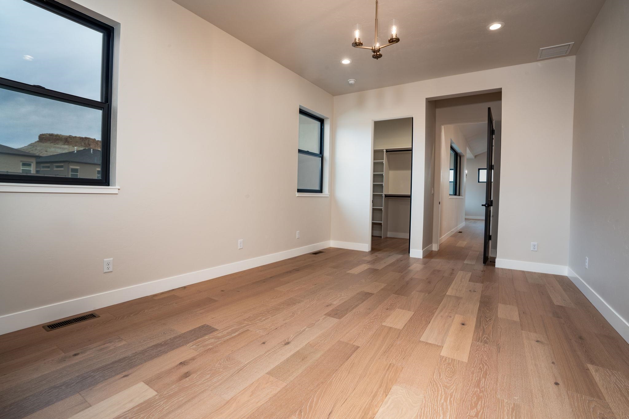 2304 Trail Ridge Road Grand Junction, CO 81507 - Photo 17 of 33 a view of an empty room with wooden floor and closet
