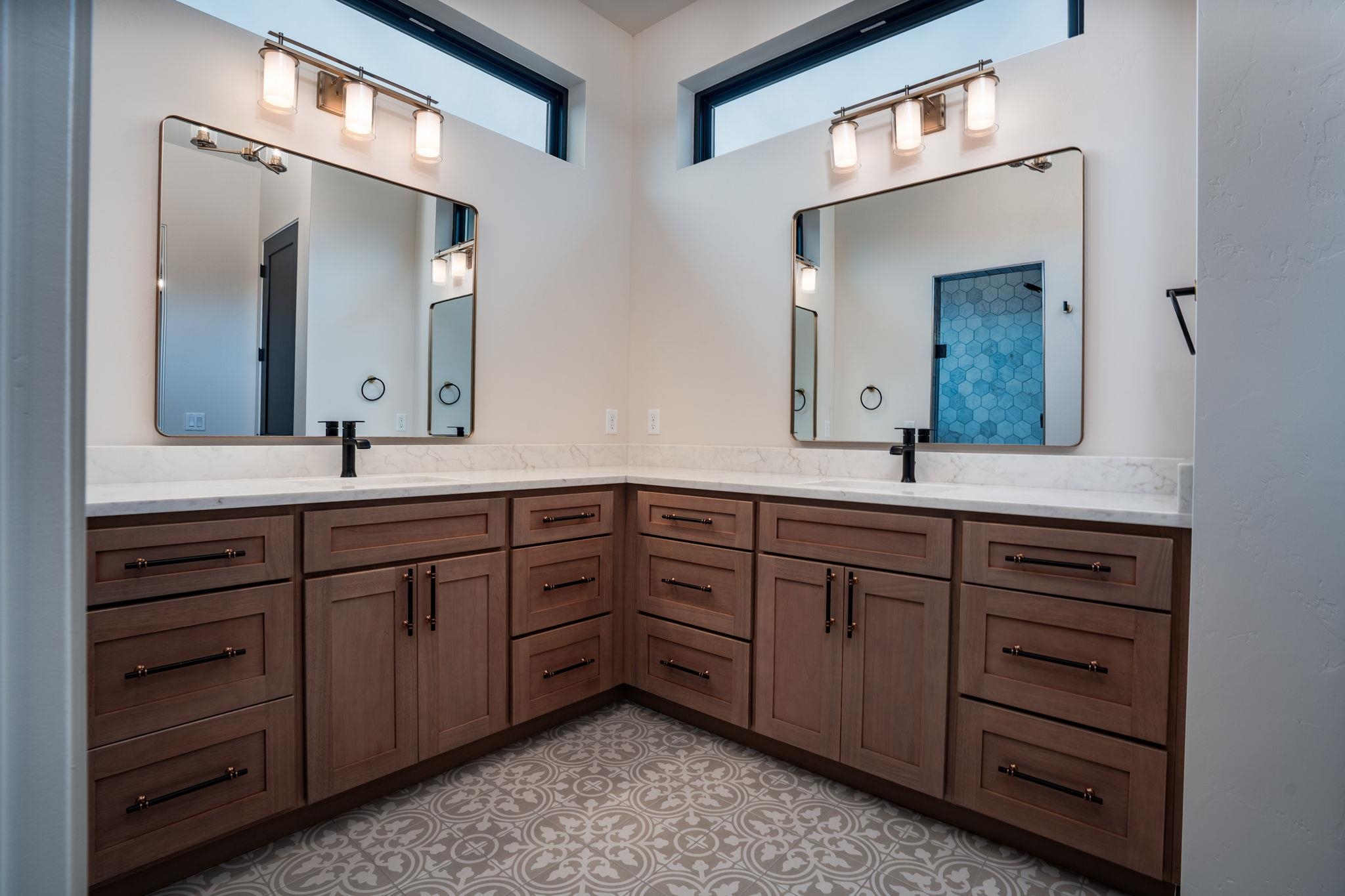 2304 Trail Ridge Road Grand Junction, CO 81507 - Photo 18 of 33 a bathroom with a double vanity sink and mirror